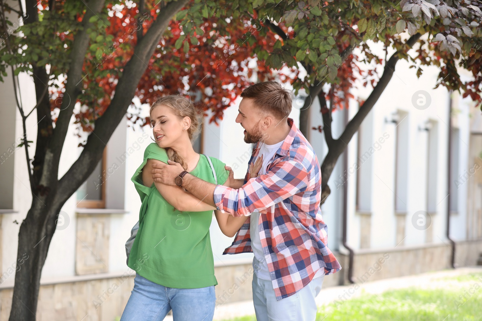 Photo of Young couple arguing on street. Problems in relationship