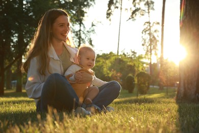 Photo of Beautiful mother with her cute daughter spending time together in park on summer day, space for text