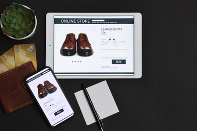 Photo of Online shopping. Flat lay composition with modern tablet and smartphone on black background