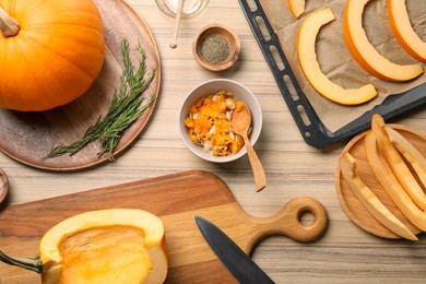 Flat lay composition with cut fresh ripe pumpkin on wooden table