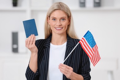 Immigration. Happy woman with passport and American flag indoors