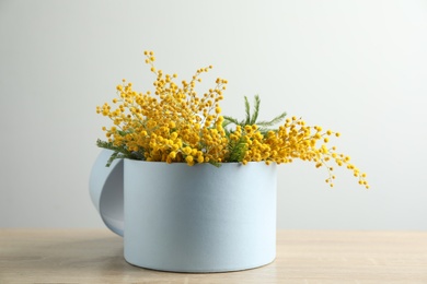 Photo of Bouquet of beautiful mimosa flowers on wooden table