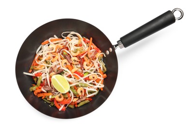 Shrimp stir fry with noodles and vegetables in wok isolated on white, top view