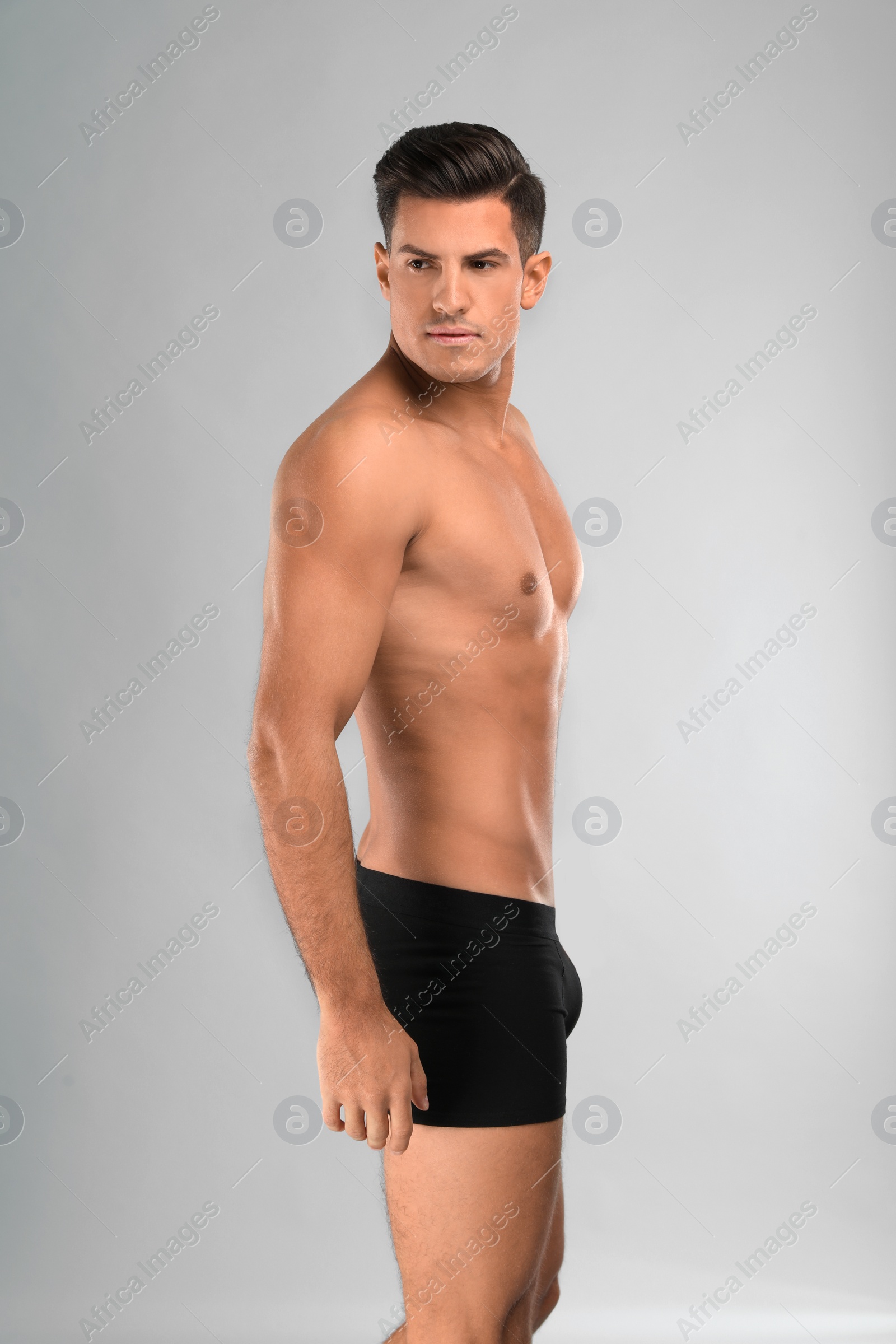 Photo of Handsome man in black underwear on light grey background