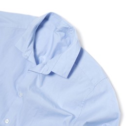 Photo of Crumpled light blue shirt on white background, top view