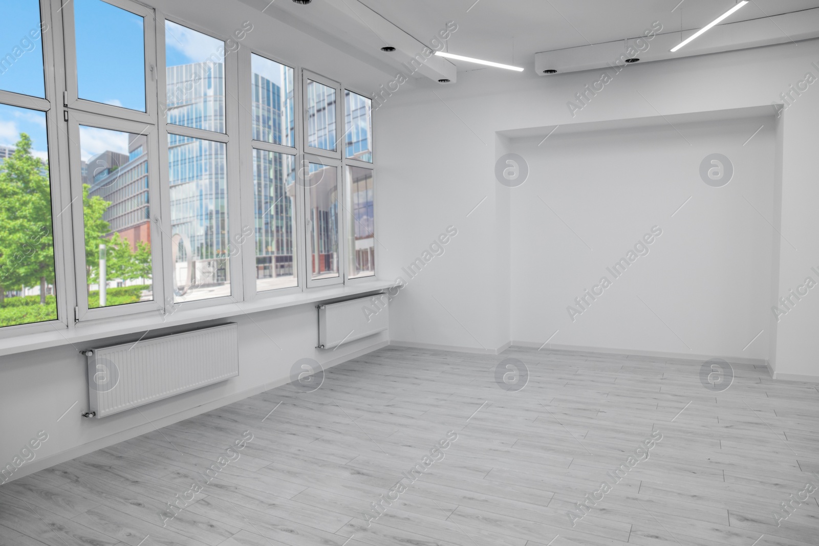 Photo of New empty room with clean windows and white walls