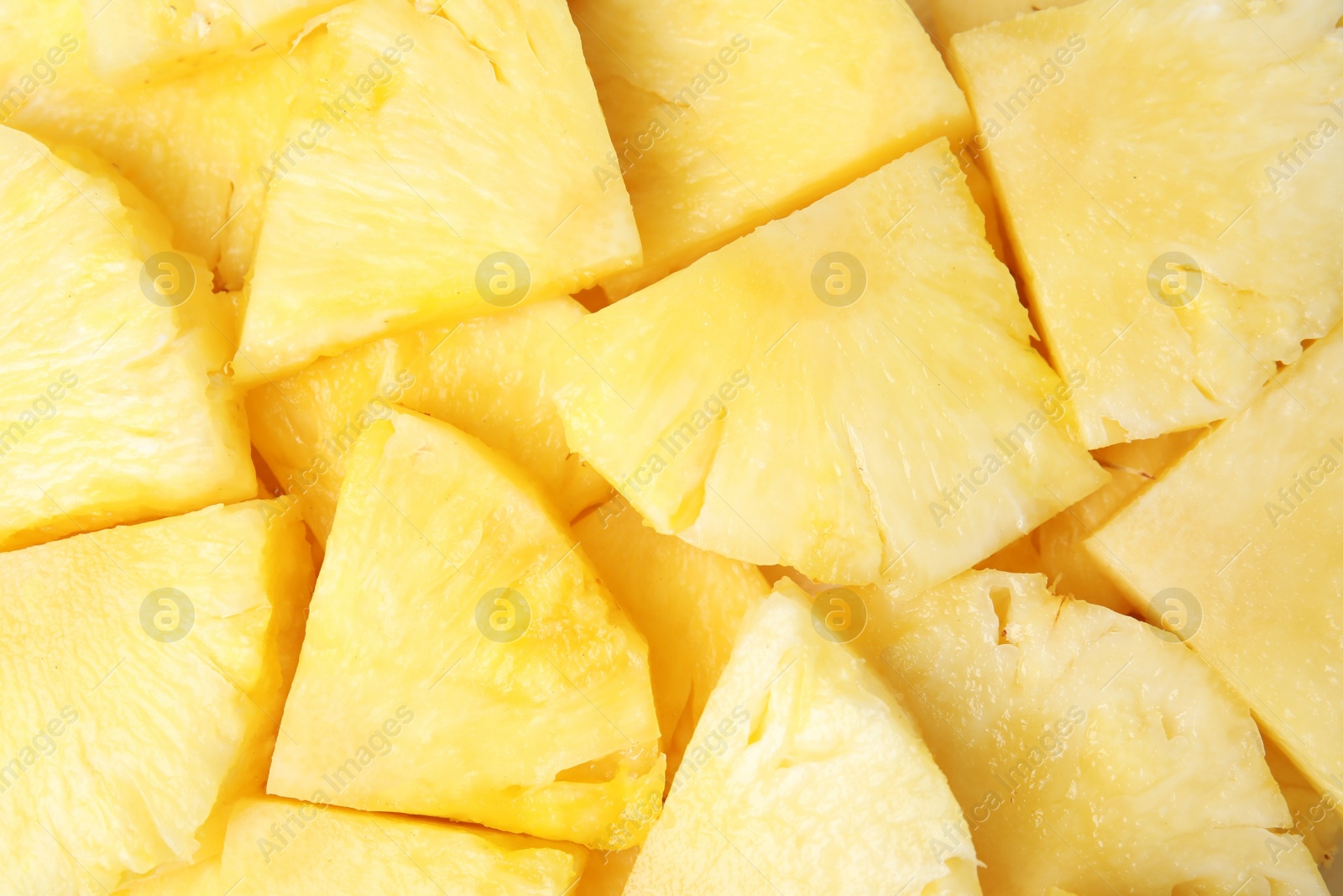 Photo of Slices of tasty ripe pineapple as background, top view