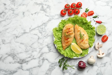 Photo of Grilled chicken breasts served on marble table, flat lay. Space for text