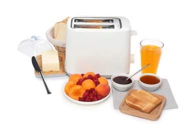 Photo of Modern toaster, bread, butter, fresh fruits, juice and jams on white background, top view