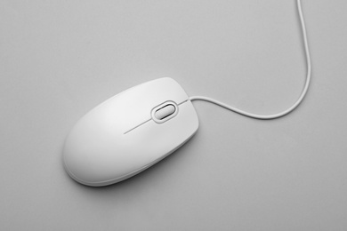 Photo of Wired computer mouse on light grey background, top view
