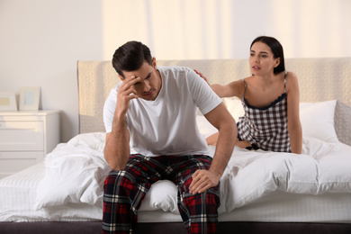 Unhappy couple with relationship problems after quarrel in bedroom