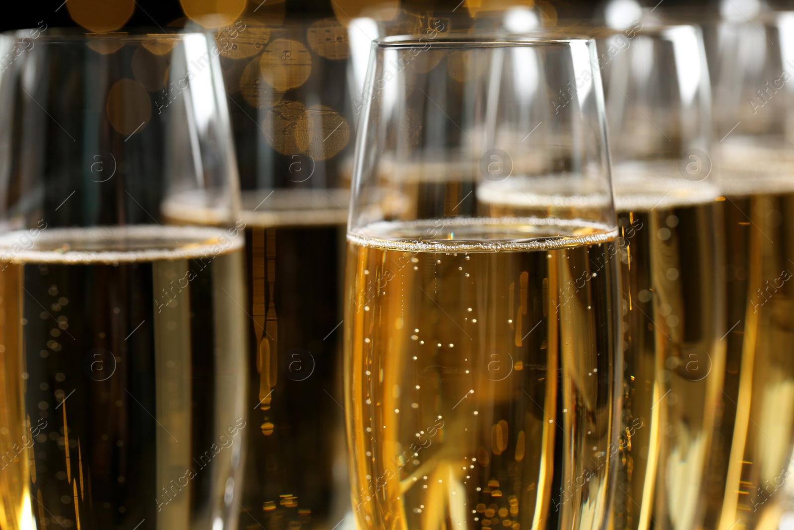 Photo of Many glasses of champagne as background, closeup