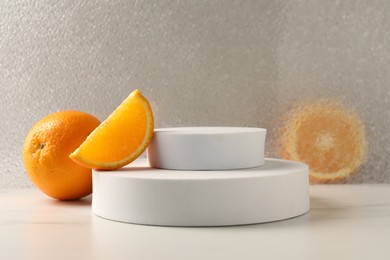 Photo of Presentation for product. Podium and tasty fresh oranges on white table, space for text