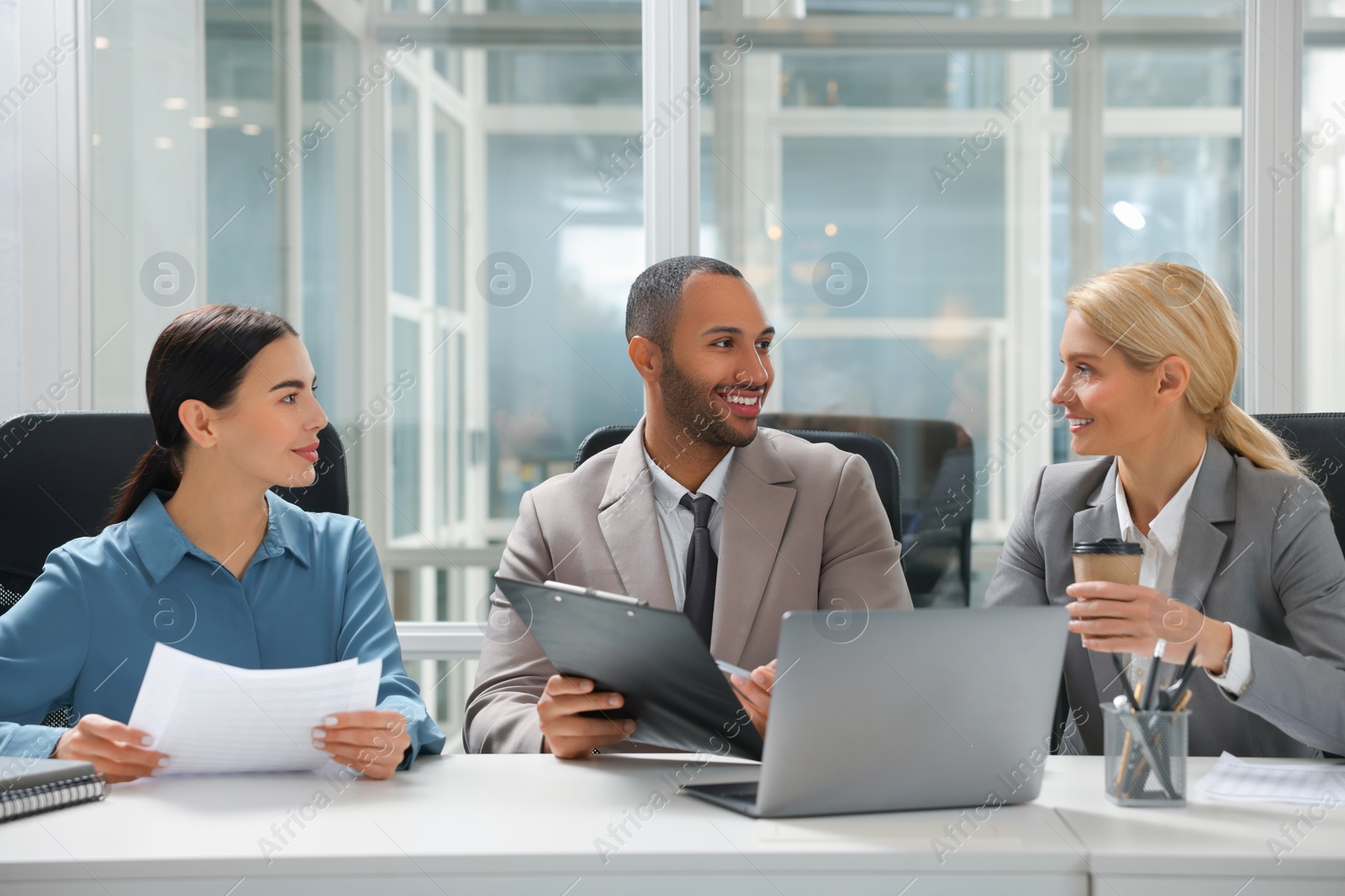 Photo of Lawyers working together at table in office