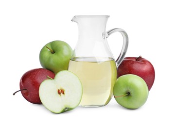 Photo of Different ripe apples and jug of juice on white background