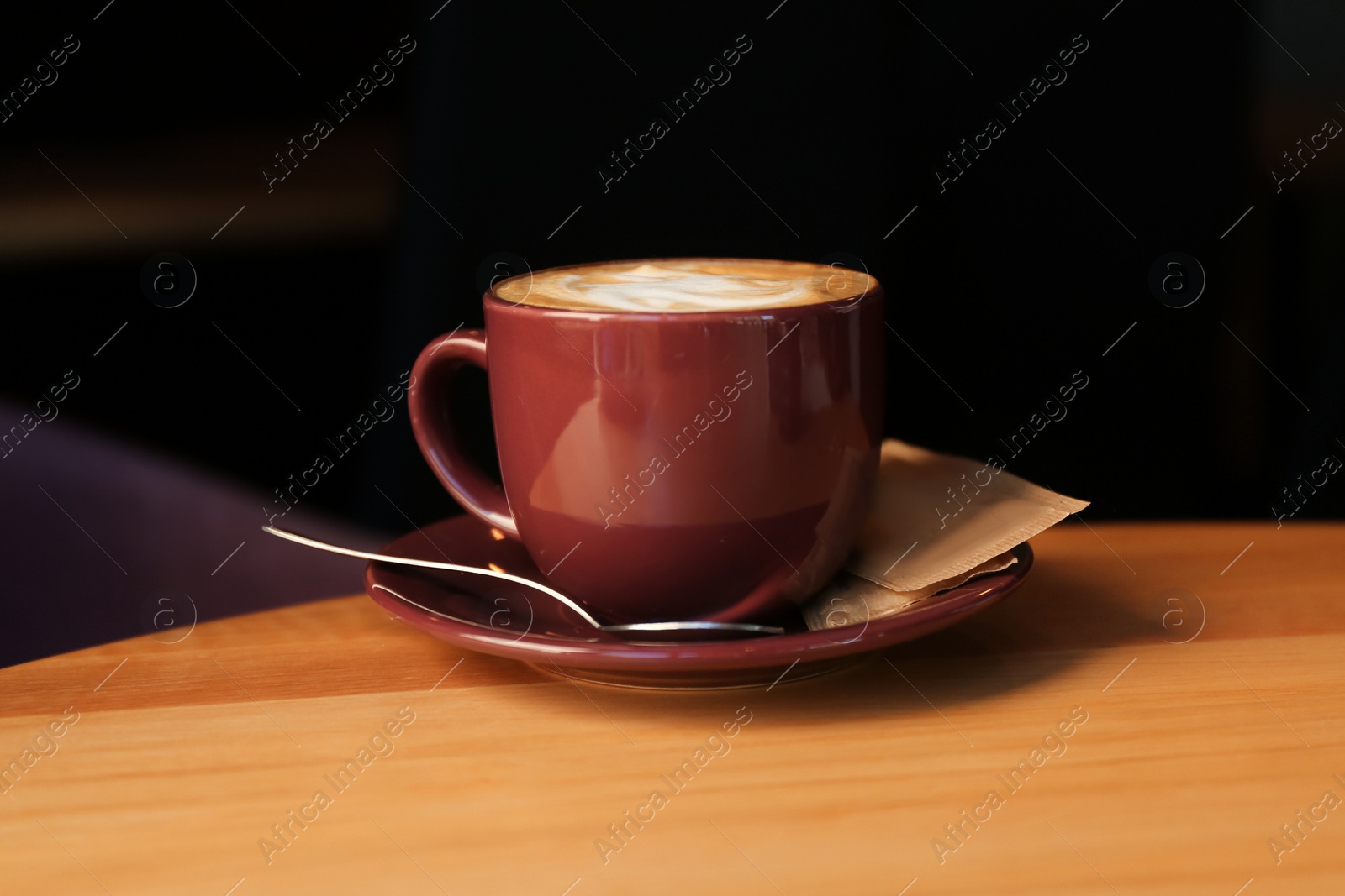 Photo of Aromatic coffee on wooden table in cafe