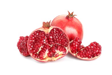 Cut and whole pomegranates isolated on white