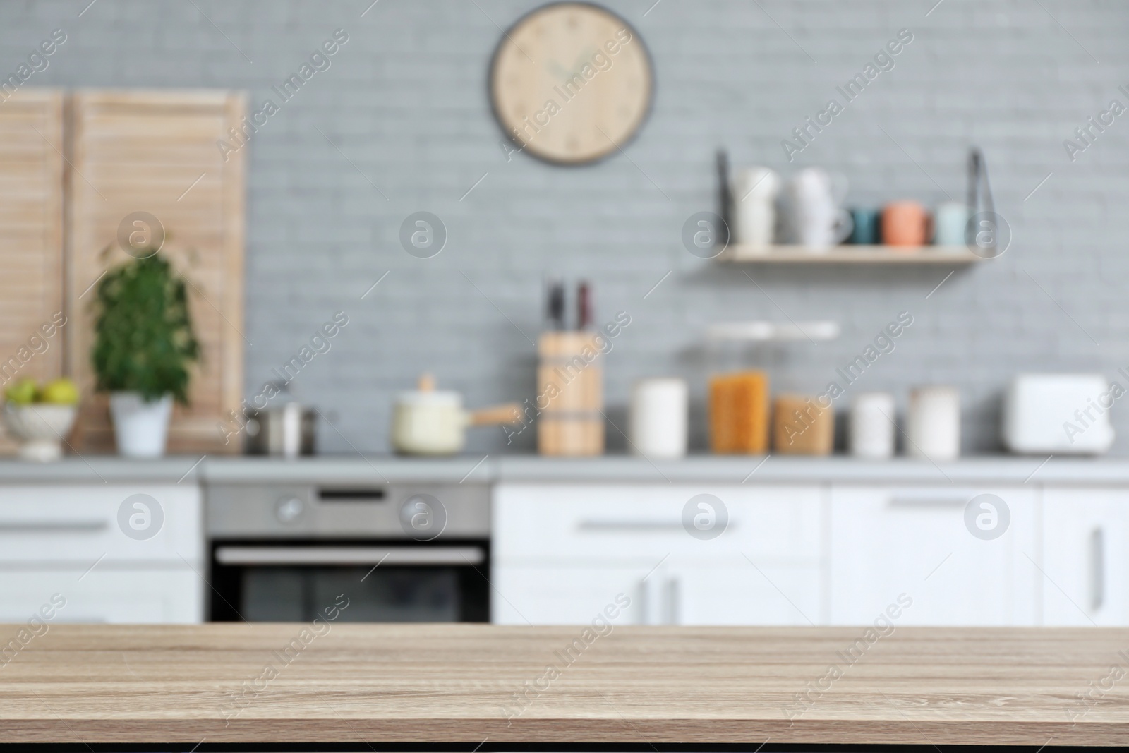 Photo of Empty table and blurred view of kitchen interior