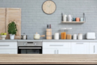 Photo of Empty table and blurred view of kitchen interior