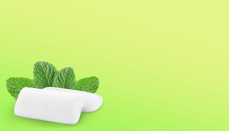 Image of Menthol chewing gum pillows and mint leaves on yellowish green background, space for text