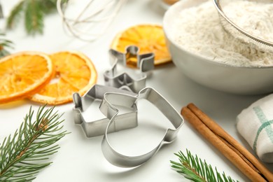 Photo of Cookie cutters on white table. Christmas biscuits