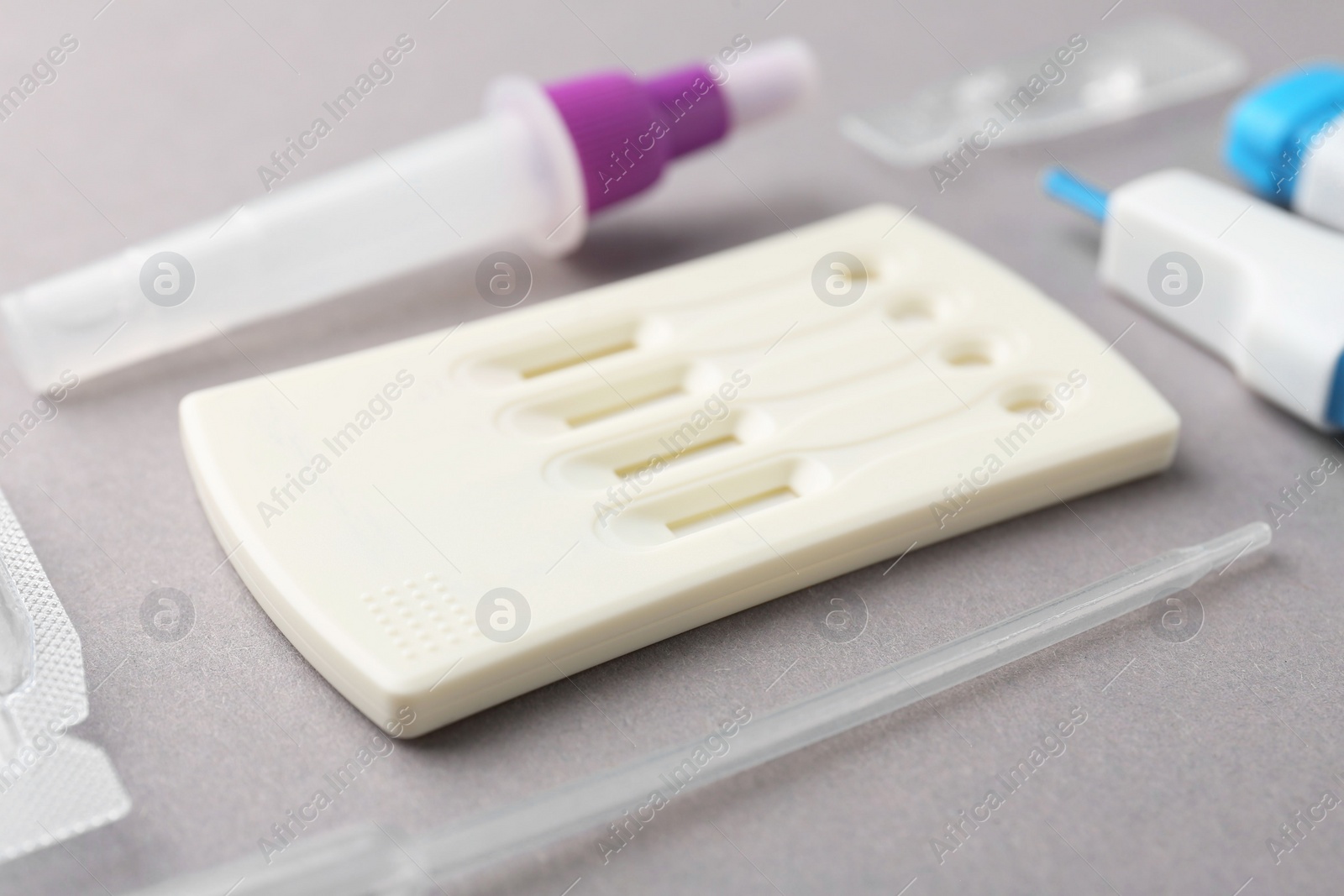 Photo of Disposable express test kit on grey background, closeup