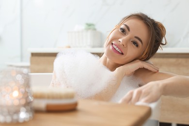 Photo of Beautiful woman enjoying bubble bath at home