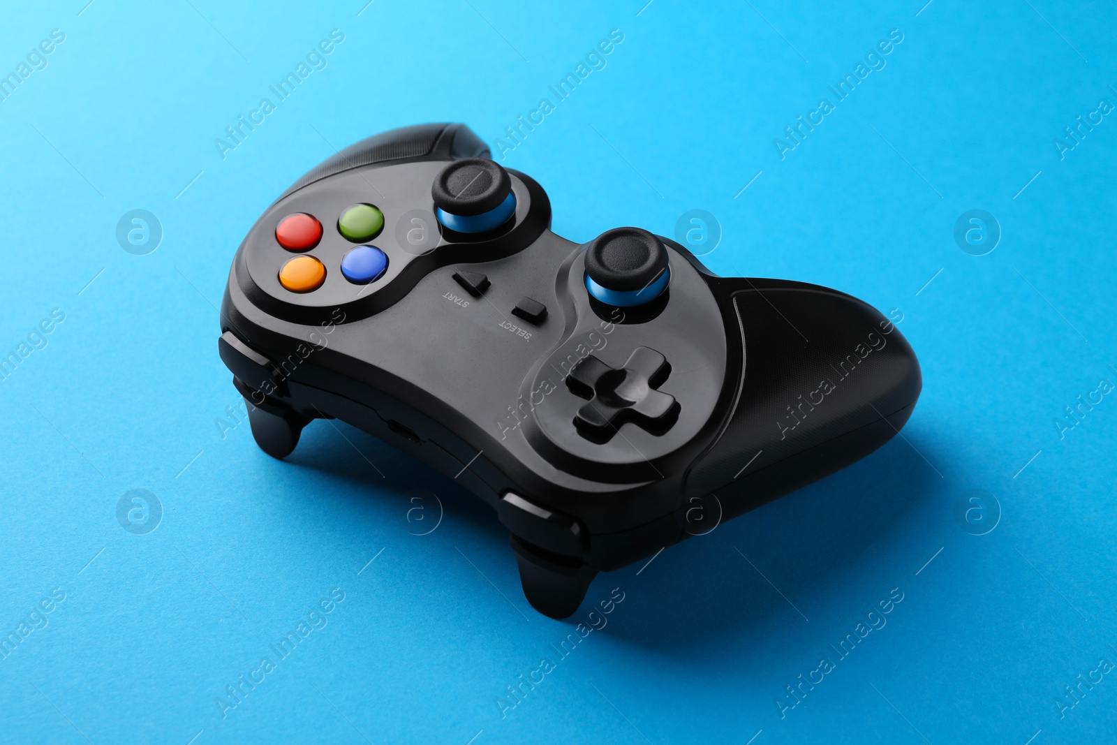 Photo of Wireless game controller on light blue background