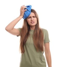Unhappy woman using cold pack to cure headache on white background