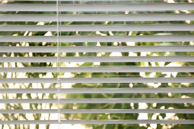Photo of Open white horizontal window blinds, closeup view