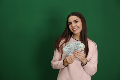 Photo of Young woman with money on color background