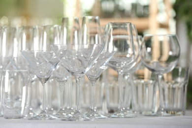 Photo of Set of empty glasses on table indoors