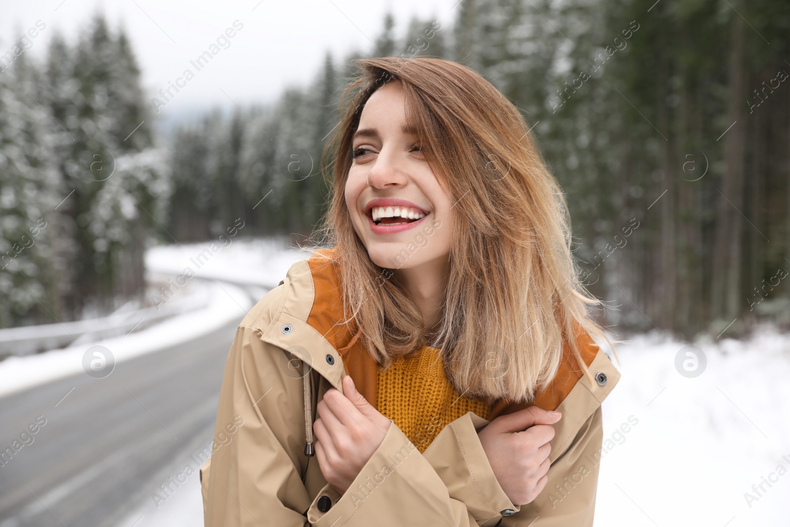 Photo of Young woman in warm clothes outdoors. Winter vacation