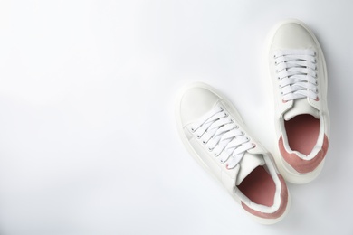 Photo of Stylish sneakers on white background, top view. Space for text