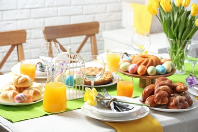 Photo of Festive Easter table setting with traditional meal at home