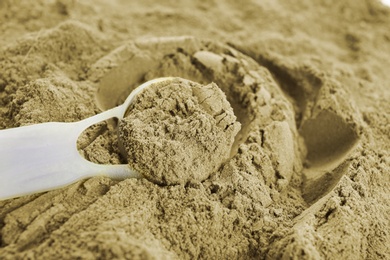 Photo of Hemp protein powder and measuring scoop, closeup