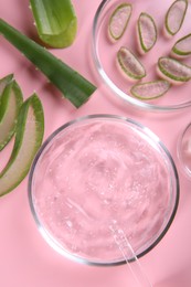 Photo of Flat lay composition with aloe vera leaves and cosmetic gel on pink background