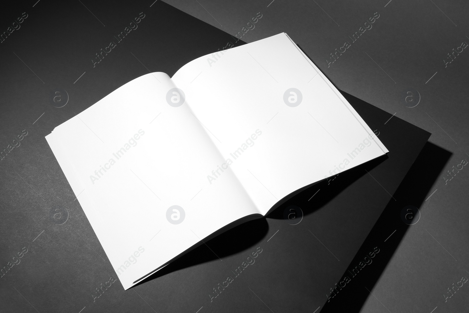 Photo of Empty book pages on dark background. Mockup for design