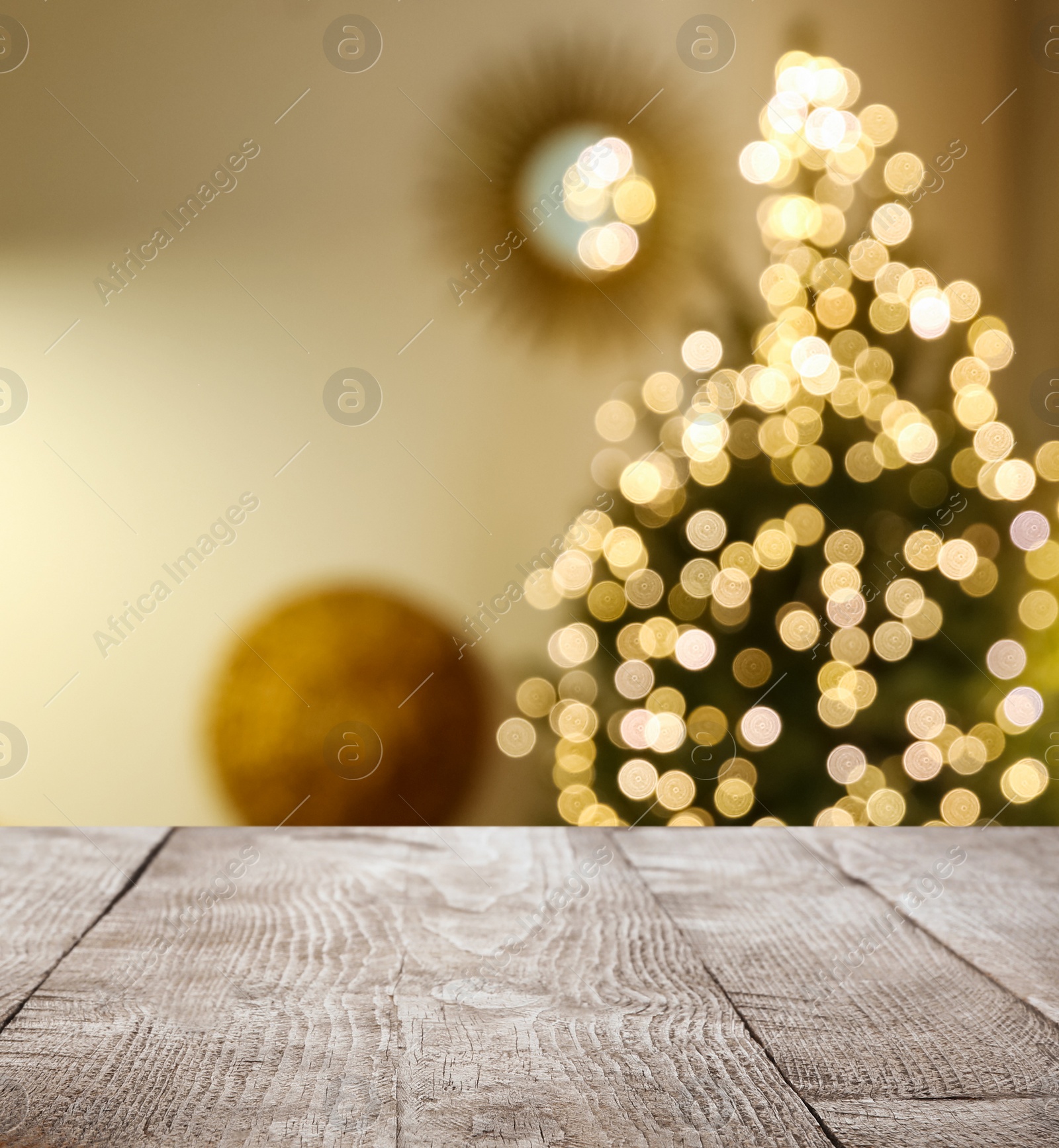 Image of Empty wooden surface and blurred view of Christmas tree in room, space for text. Interior design