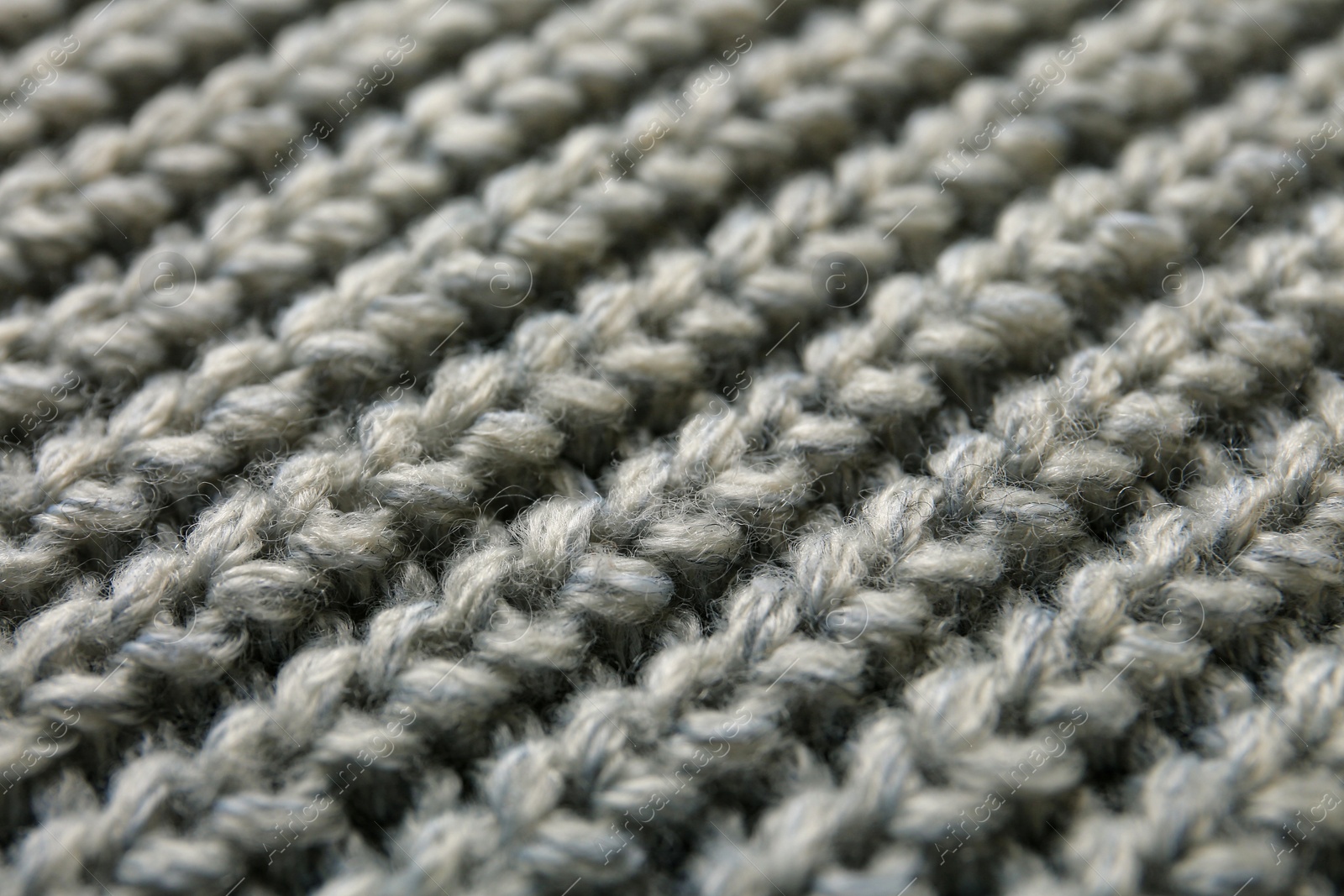 Photo of Beautiful grey knitted fabric as background, closeup