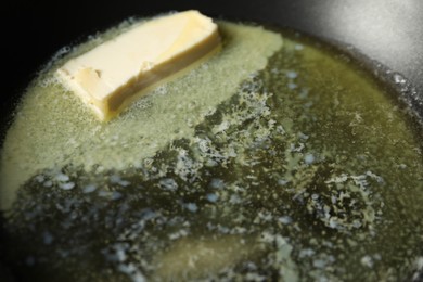 Photo of Melting butter in frying pan, closeup view