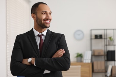 Portrait of smiling young man in office, space for text. Lawyer, businessman, accountant or manager