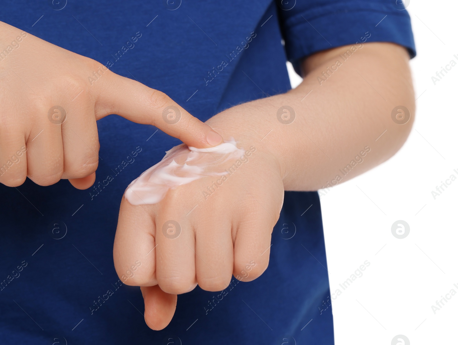 Photo of Child applying ointment onto hand isolated on white, closeup