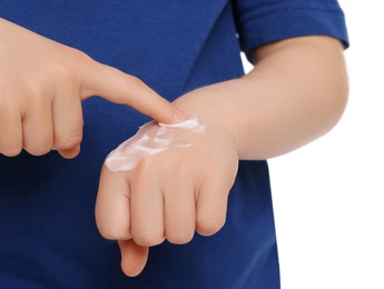 Photo of Child applying ointment onto hand isolated on white, closeup