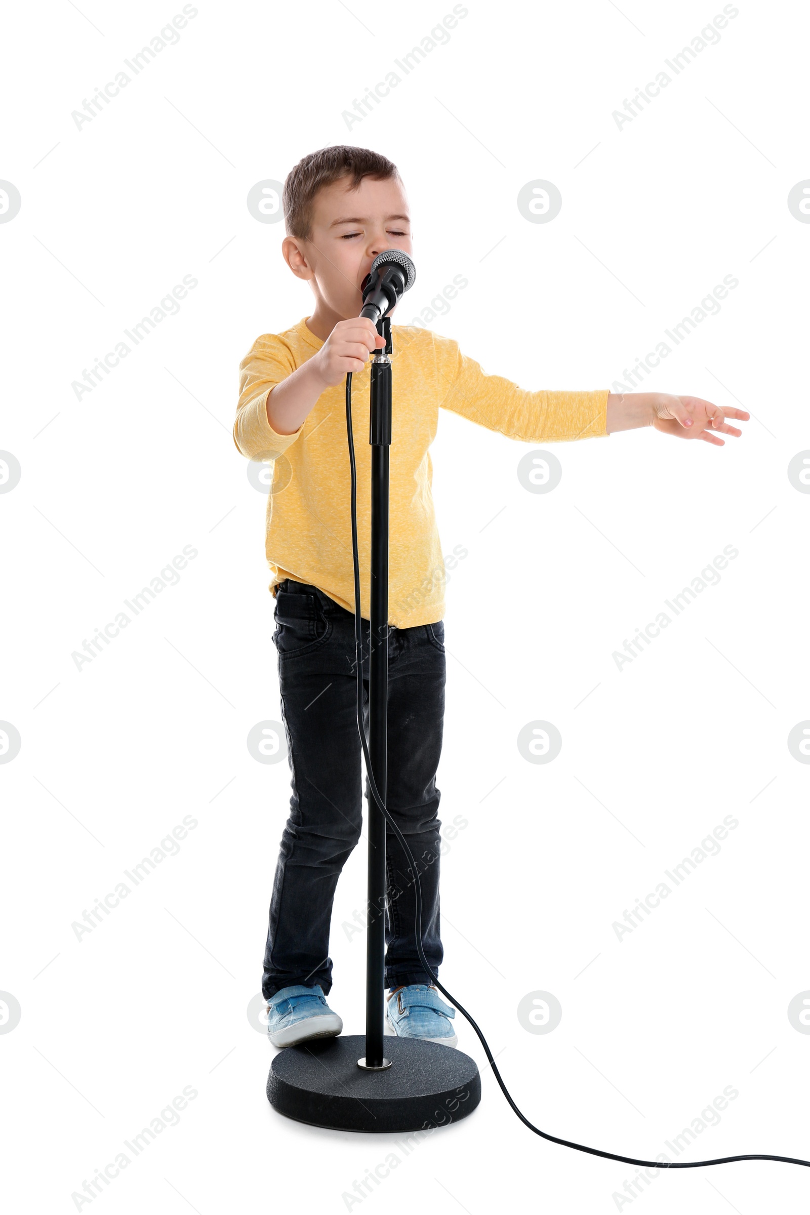 Photo of Cute funny boy with microphone on white background