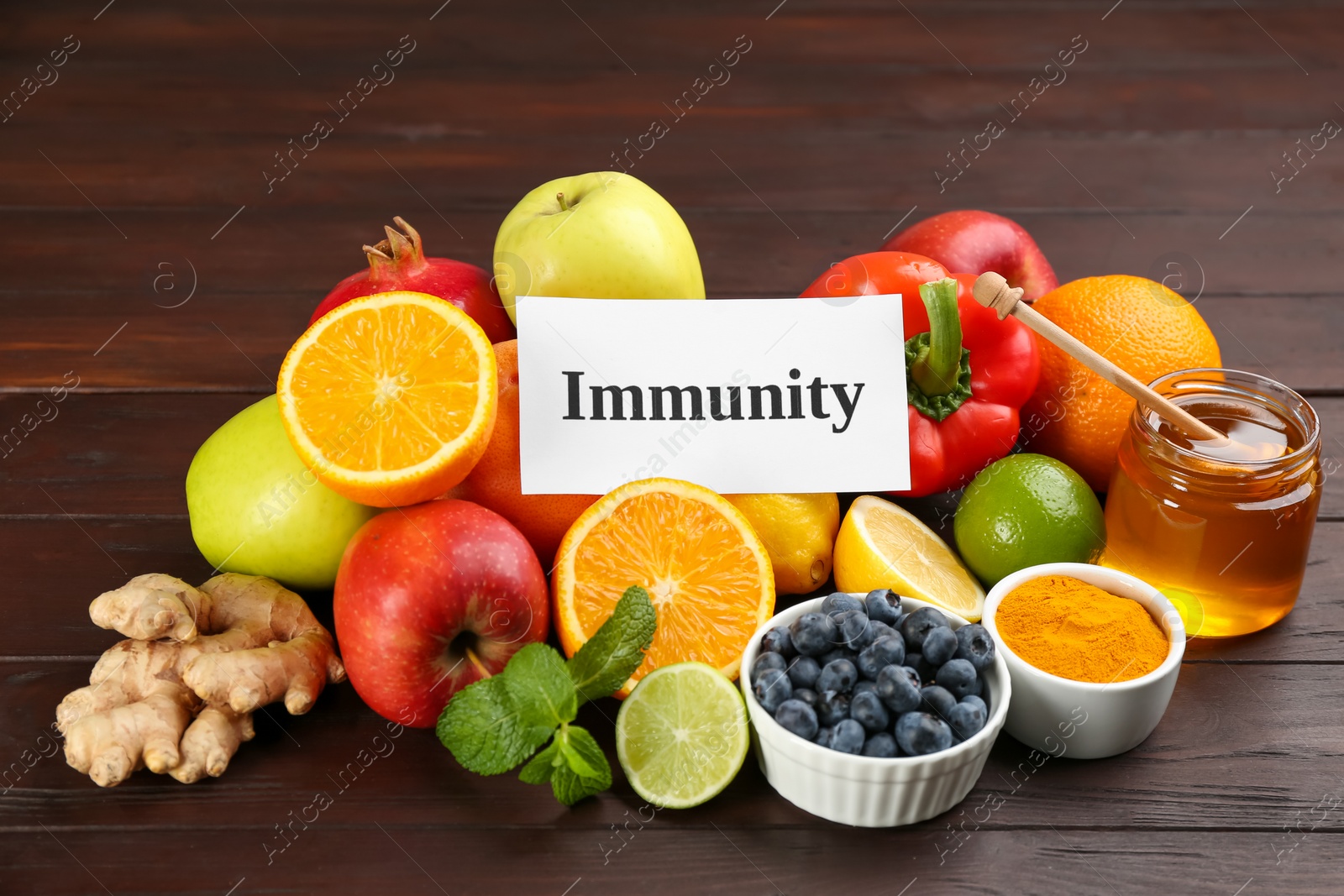 Photo of Card with word Immunity and fresh products on wooden table