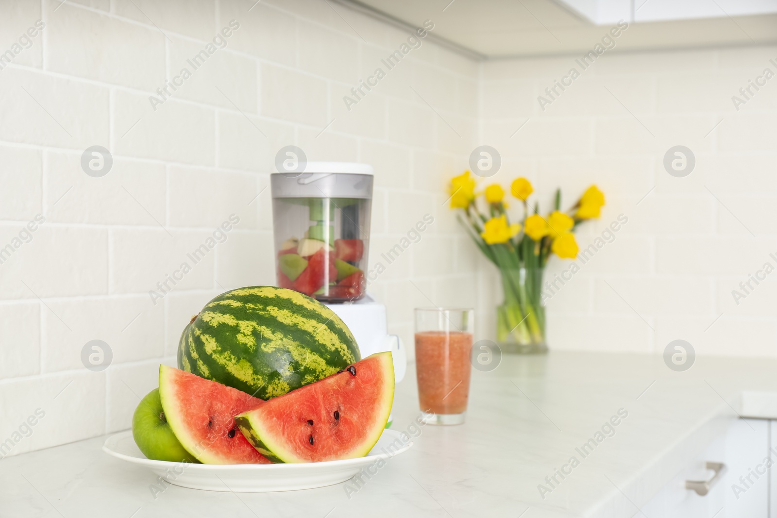 Photo of Blender and smoothie ingredients on counter in kitchen