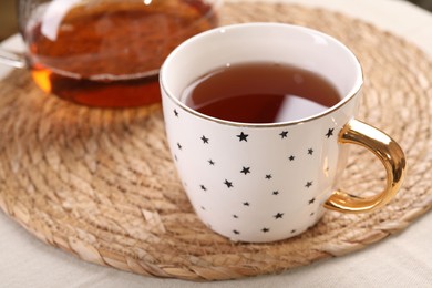 Aromatic tea in cup on table, closeup