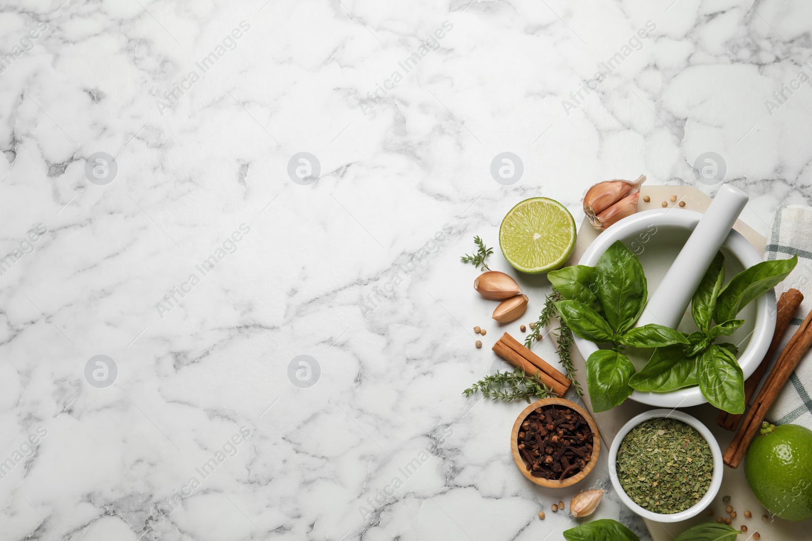 Photo of Different natural spices and herbs on white marble table, flat lay. Space for text