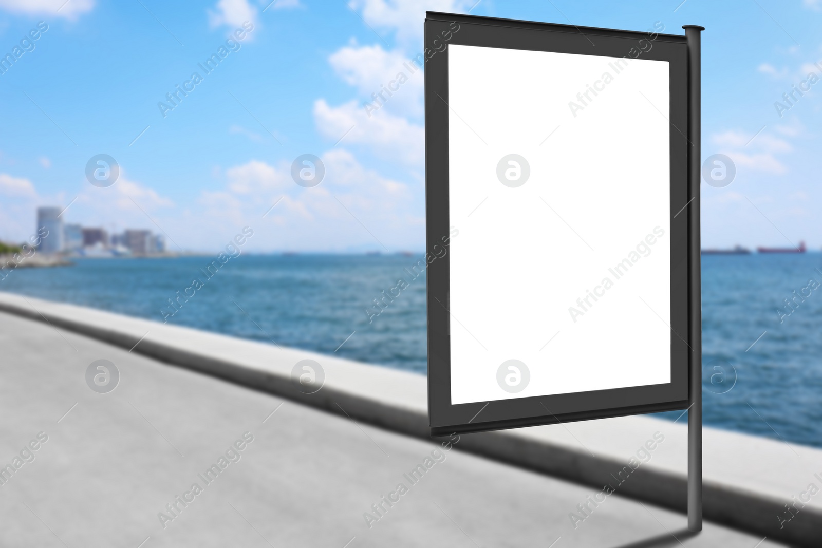 Image of Blank advertising board on street near sea. Space for text